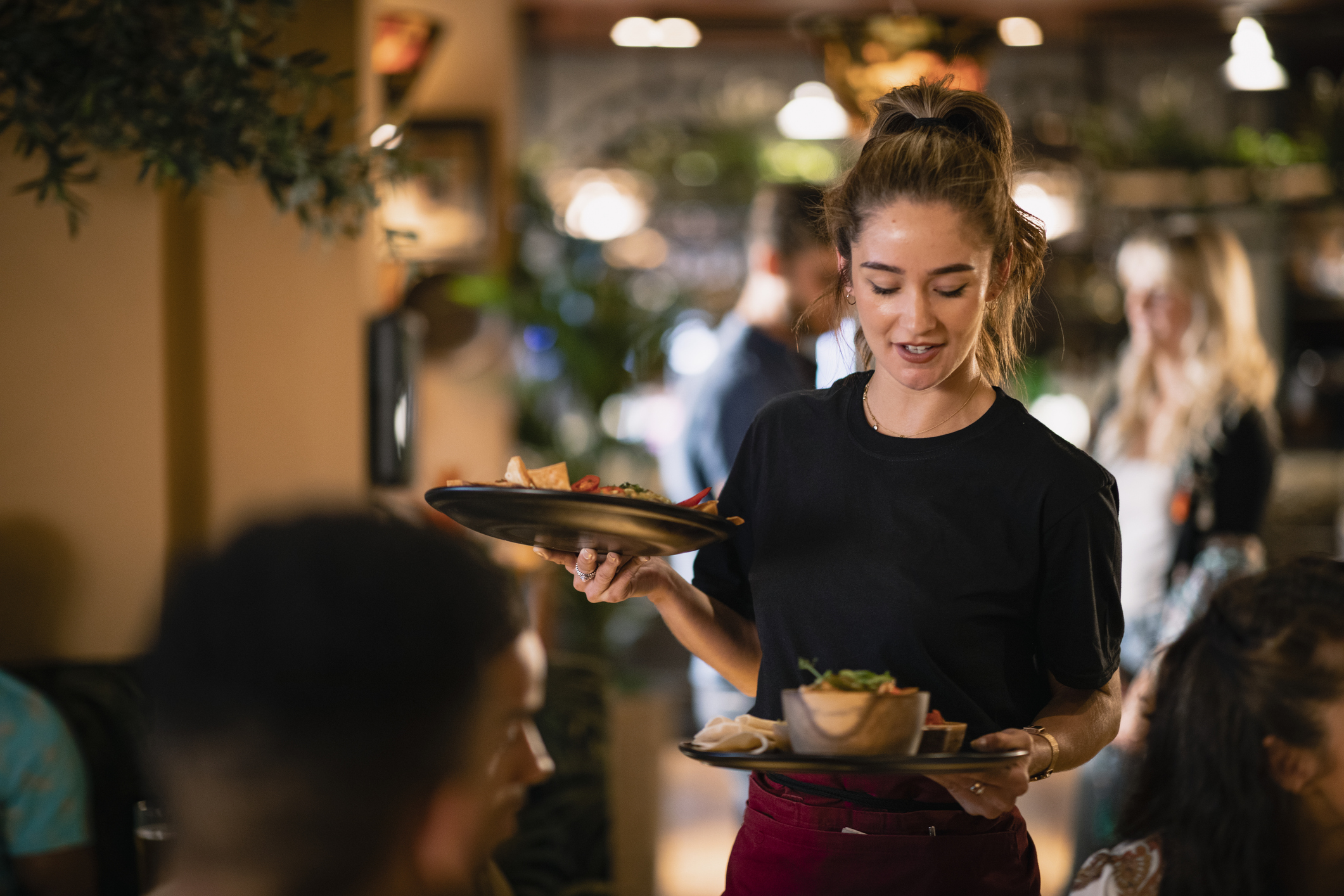 A waitress serving customers food at a restaurant