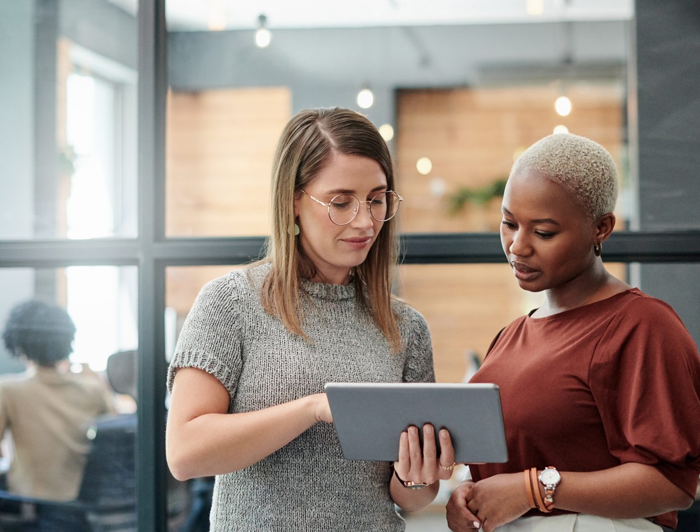 Two businesswomen having a discussion with a tablet