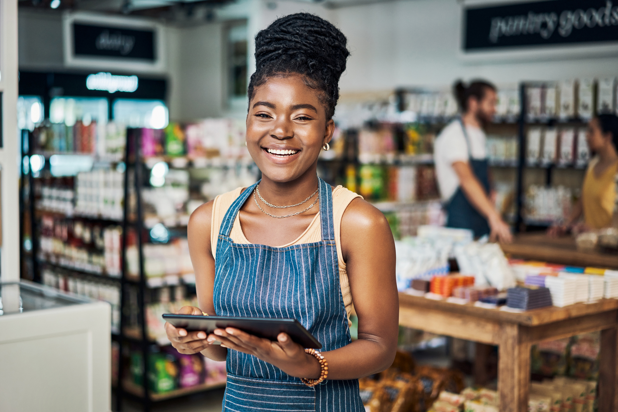 Young female employee using a digital tablet while working in an organic store