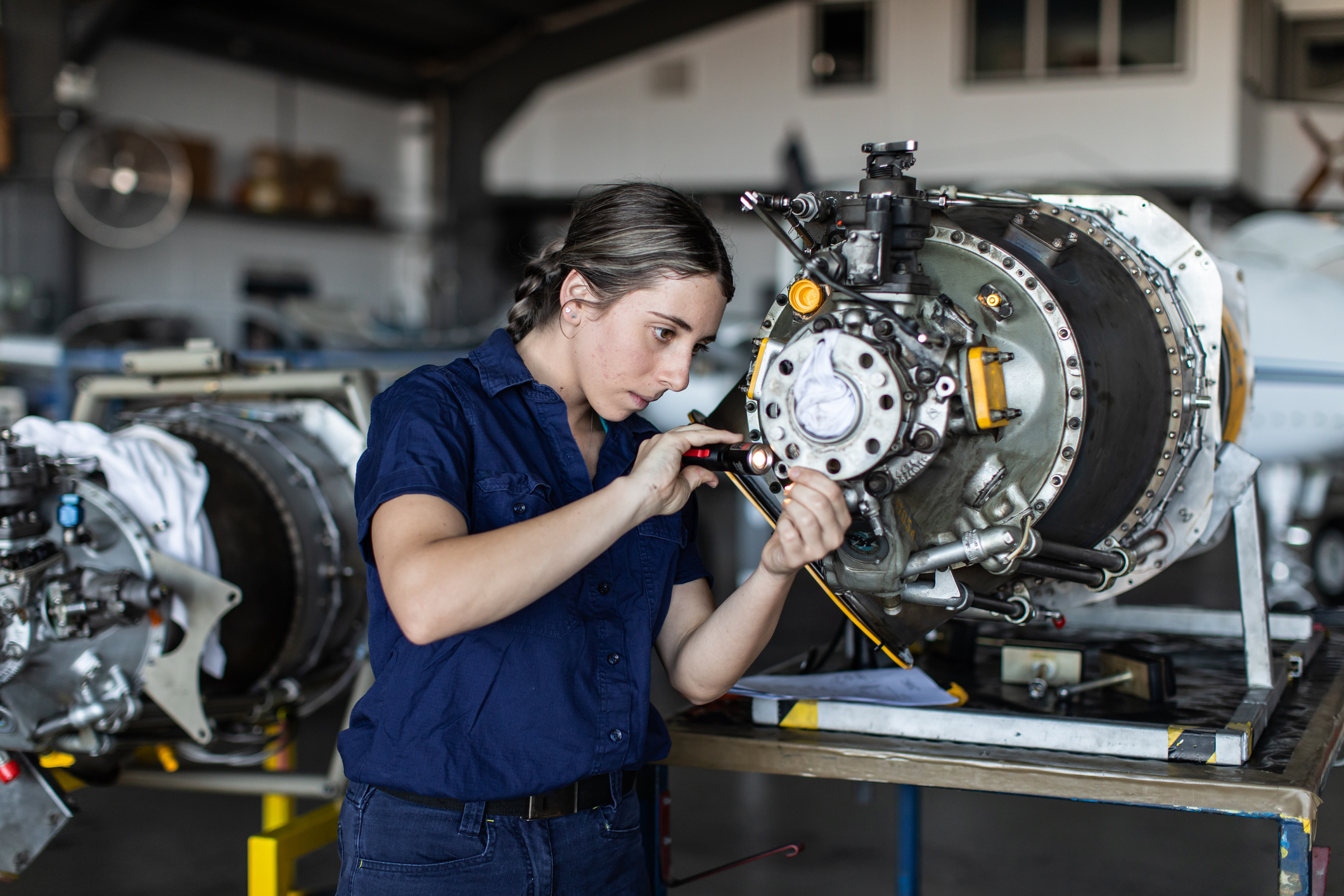 Young female aircraft engineer apprentice at work