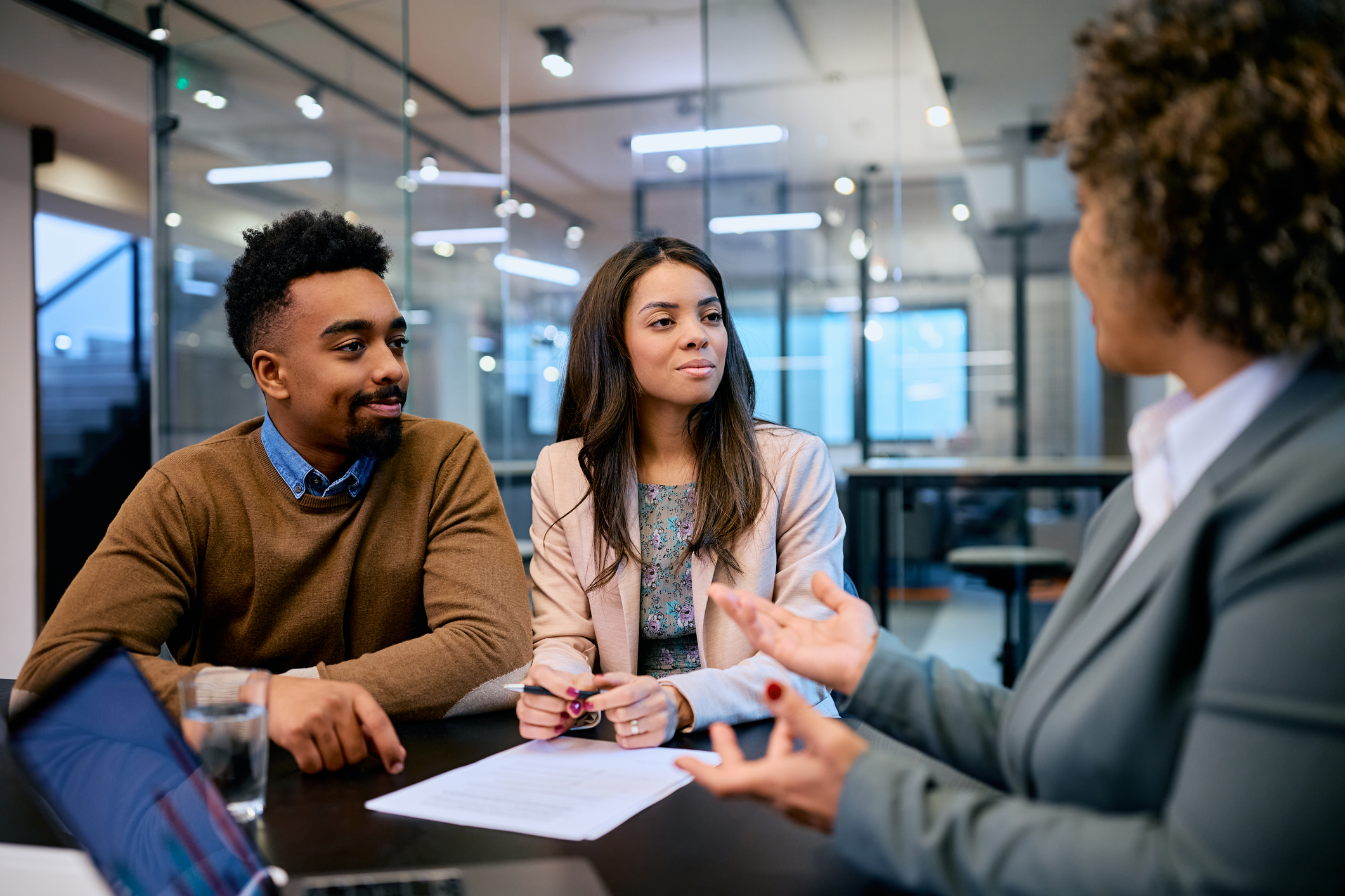 Young couple consulting with their advisor in the office.