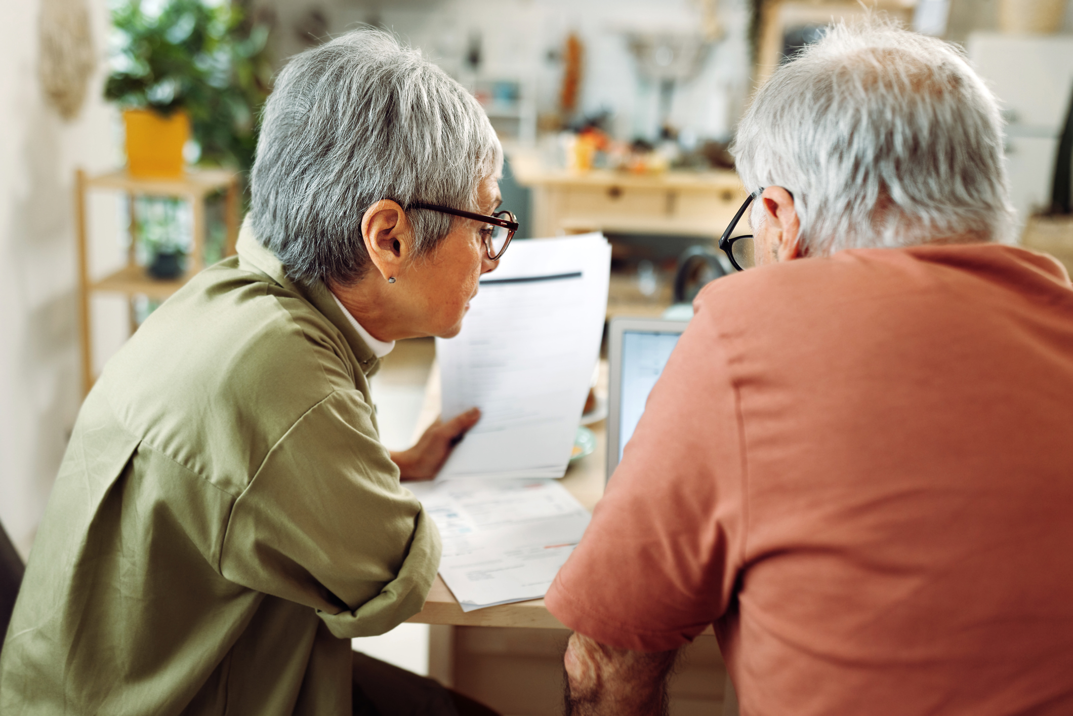 Senior couple going over paperwork at home.